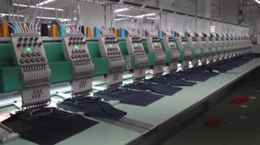 Ba Ria, VIETNAM - MAR 18 2022: Modern and automatic high technology sewing machine for textile or clothing apparel making manufacturing process in industrial. Close up Computerized embroidery machines