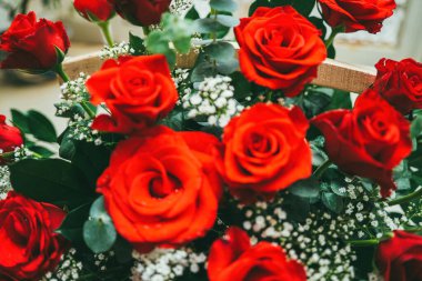 Bouquet of fresh red roses, flower bright background. Close up of a red rose with water droplets.