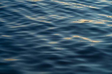 Sunset water reflect ripples at sun light. Abstract golden reflection on water sunset