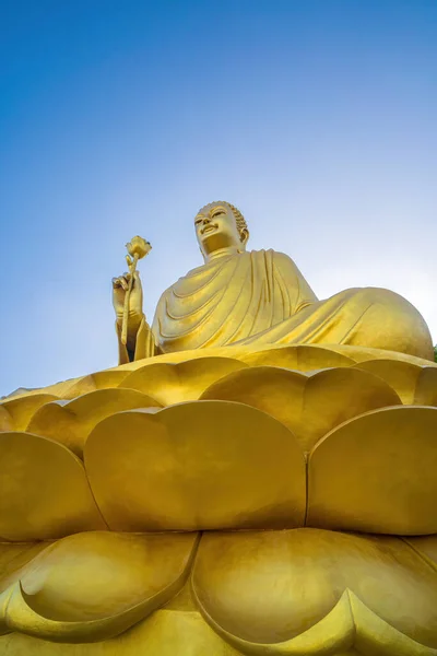 Golden Buddha statue\'s hand holding lotus at Chon Khong Monastery.