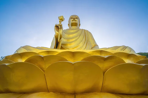 Golden Buddha statue\'s hand holding lotus at Chon Khong Monastery.