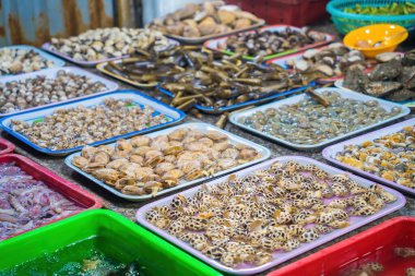 Variety of fresh seafood on market. Fresh salmon, sea bass, red snapper, mackerel, crab, lobster, shrimp, black mussels, oyster, scallop and octopus on ice in market