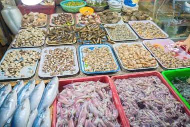 Variety of fresh seafood on market. Fresh salmon, sea bass, red snapper, mackerel, crab, lobster, shrimp, black mussels, oyster, scallop and octopus on ice in market