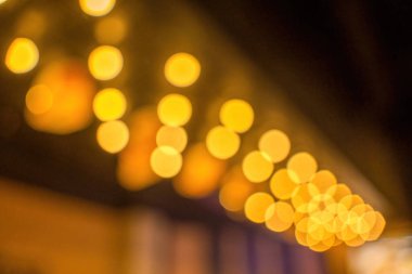 Blurred Night city bokeh glows light background empty. Banner candlelight shines yellow gold glitter abstract. Design background Celebration