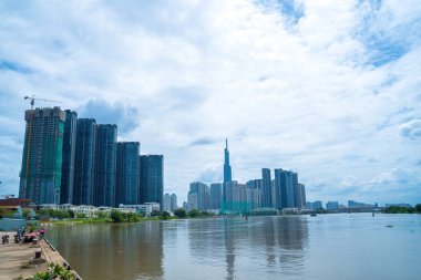 View at Landmark 81 - it is a super tall skyscraper and Saigon bridge with development buildings along Saigon river light smooth down