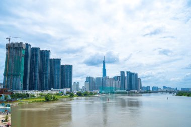 View at Landmark 81 - it is a super tall skyscraper and Saigon bridge with development buildings along Saigon river light smooth down