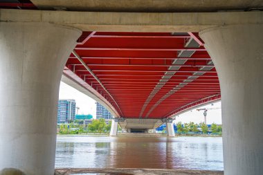 Under Thu Thiem 2 bridge, connecting Thu Thiem peninsula and District 1 across the Saigon River in Bach Dang port