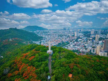 Vung Tau, Viet Nam - JUN 09 2022: Aerial view of Vung Tau with statue of Jesus Christ on Moutain . the most popular local place. Christ the King, a statue of Jesus. Travel concept.
