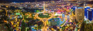 Panoramic coastal Vung Tau view from above, with traffic roundabout, house, Vietnam war memorial in Vietnam. Long exposure photography at night.