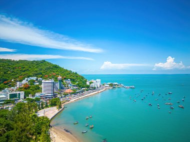 Vung Tau city aerial view with beautiful sunset and so many boats. Panoramic coastal Vung Tau view from above, with waves, coastline, streets, coconut trees and Tao Phung mountain in Vietnam.