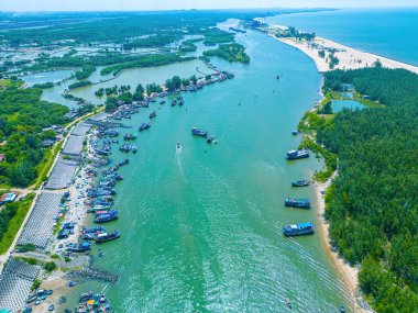 Beautiful blue skyline panoramic in Loc An Canal. Scenery landscape of fishing port with tsunami protection concrete blocks. Cityscape and boats in the sea. Loc An village near Vung Tau City.