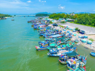 Beautiful blue skyline panoramic in Loc An Canal. Scenery landscape of fishing port with tsunami protection concrete blocks. Cityscape and boats in the sea. Loc An village near Vung Tau City.