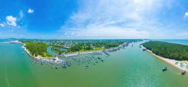 Beautiful blue skyline panoramic in Loc An Canal. Scenery landscape of fishing port with tsunami protection concrete blocks. Cityscape and boats in the sea. Loc An village near Vung Tau City.