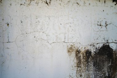 Texture of old black concrete wall for background.  Rough texture on black wall rough form due to peeling paint layer due to rain