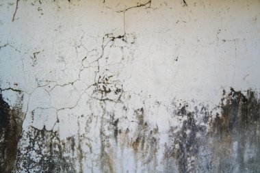 Texture of old black concrete wall for background.  Rough texture on black wall rough form due to peeling paint layer due to rain