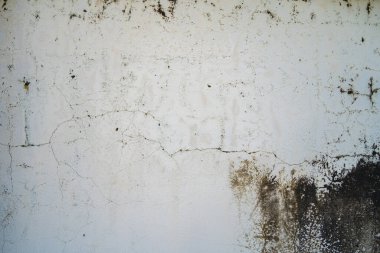 Texture of old black concrete wall for background.  Rough texture on black wall rough form due to peeling paint layer due to rain