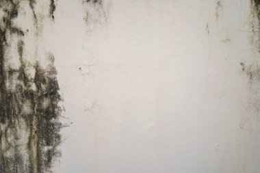 Texture of old black concrete wall for background.  Rough texture on black wall rough form due to peeling paint layer due to rain