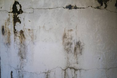 Texture of old black concrete wall for background.  Rough texture on black wall rough form due to peeling paint layer due to rain