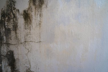 Texture of old black concrete wall for background.  Rough texture on black wall rough form due to peeling paint layer due to rain