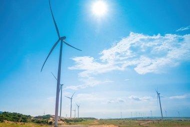 Panoramic view of wind farm or wind park, with high wind turbines for generation electricity with copy space at Phan Thiet, Mui Ne, Bau Trang. Green energy concept.