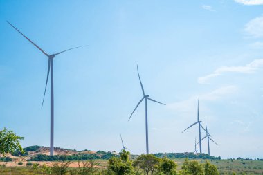 Panoramic view of wind farm or wind park, with high wind turbines for generation electricity with copy space at Phan Thiet, Mui Ne, Bau Trang. Green energy concept.
