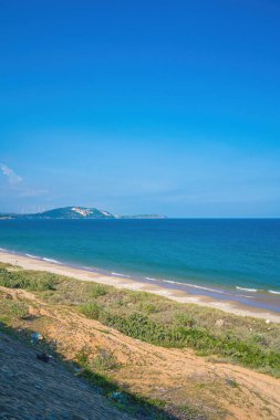 Mui Ne city, Binh Thua aerial view with beautiful sunset and so many boats. Panoramic coastal Mui Ne view from above, with waves, coastline, streets, coconut trees. Phan Thiet