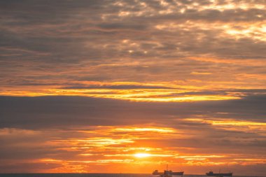 Calm sea with sunset sky and sun through the clouds over. Calm sea with sunset sky and sun through the clouds over. Meditation ocean and sky background. Tranquil seascape. Horizon over the water.