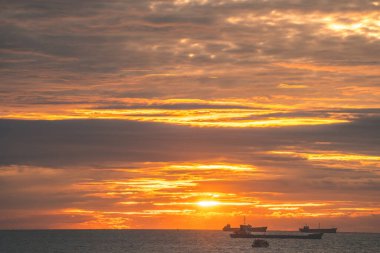 Calm sea with sunset sky and sun through the clouds over. Calm sea with sunset sky and sun through the clouds over. Meditation ocean and sky background. Tranquil seascape. Horizon over the water.