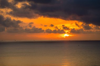 Calm sea with sunset sky and sun through the clouds over. Calm sea with sunset sky and sun through the clouds over. Meditation ocean and sky background. Tranquil seascape. Horizon over the water.