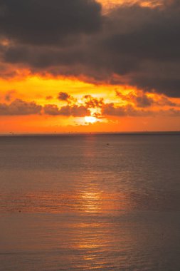 Calm sea with sunset sky and sun through the clouds over. Calm sea with sunset sky and sun through the clouds over. Meditation ocean and sky background. Tranquil seascape. Horizon over the water.