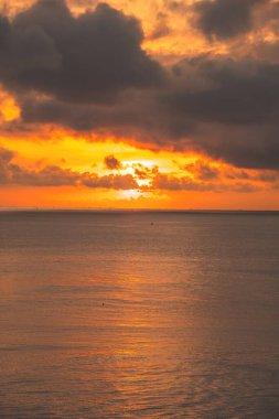 Calm sea with sunset sky and sun through the clouds over. Calm sea with sunset sky and sun through the clouds over. Meditation ocean and sky background. Tranquil seascape. Horizon over the water.