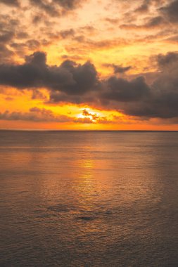 Calm sea with sunset sky and sun through the clouds over. Calm sea with sunset sky and sun through the clouds over. Meditation ocean and sky background. Tranquil seascape. Horizon over the water.