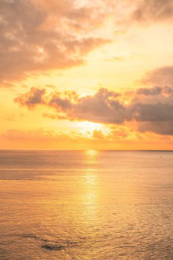 Calm sea with sunset sky and sun through the clouds over. Calm sea with sunset sky and sun through the clouds over. Meditation ocean and sky background. Tranquil seascape. Horizon over the water.