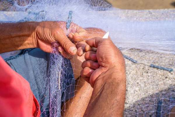 Fisherman casting his net at the sunrise or sunset. Traditional fishermen prepare the fishing net. Fishermen on beach at the Fishing.