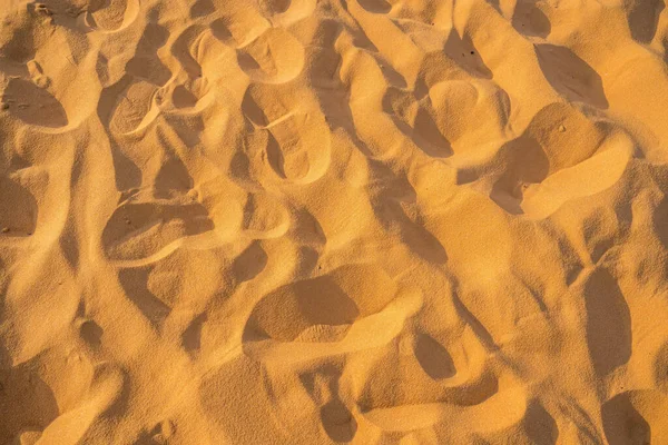 Close up of sand pattern of a beach in the summer. Sand texture background. Brown desert pattern from tropical beach.