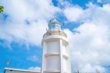 Focus white Lighthouse in Vung Tau. The most visited tourist location in the Vung Tau city and famous Lighthouse captured with blue sky and cloud.