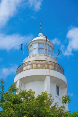 Focus white Lighthouse in Vung Tau. The most visited tourist location in the Vung Tau city and famous Lighthouse captured with blue sky and cloud.