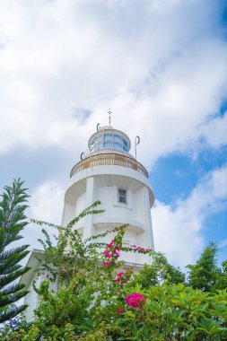 Focus white Lighthouse in Vung Tau. The most visited tourist location in the Vung Tau city and famous Lighthouse captured with blue sky and cloud.