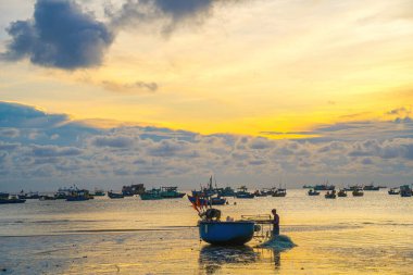 Beautiful cloudscape over the sea, sunrise shot. Lonely boats. Calm sea with sunset sky and sun through the clouds over. Calm sea with sunset sky or sunrise and sun through the clouds over.