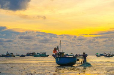 Beautiful cloudscape over the sea, sunrise shot. Lonely boats. Calm sea with sunset sky and sun through the clouds over. Calm sea with sunset sky or sunrise and sun through the clouds over.