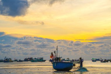 Beautiful cloudscape over the sea, sunrise shot. Lonely boats. Calm sea with sunset sky and sun through the clouds over. Calm sea with sunset sky or sunrise and sun through the clouds over.