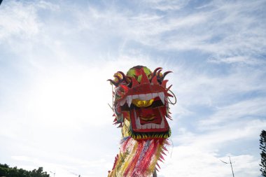 A head of Chinese Dragon dance in the Chinese new year festival. Lion and dragon dance during Chinese New Year celebration. Group of people perform a traditional lion dance.