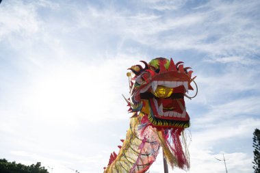 A head of Chinese Dragon dance in the Chinese new year festival. Lion and dragon dance during Chinese New Year celebration. Group of people perform a traditional lion dance.