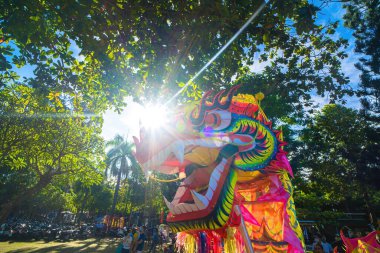 A head of Chinese Dragon dance in the Chinese new year festival. Lion and dragon dance during Chinese New Year celebration. Group of people perform a traditional lion dance.