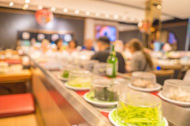 Blurred background Interior of cozy restaurant. Contemporary design in loft style, modern dining place and bar counter, copy space. Hot pot conveyor.