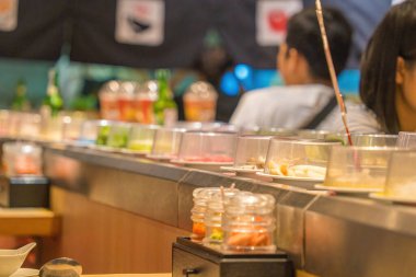Blurred background Interior of cozy restaurant. Contemporary design in loft style, modern dining place and bar counter, copy space. Hot pot conveyor.