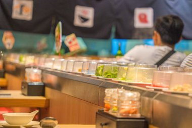 Blurred background Interior of cozy restaurant. Contemporary design in loft style, modern dining place and bar counter, copy space. Hot pot conveyor.