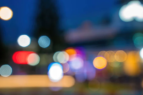 Abstract background of city street in bokeh. Blur focused urban abstract texture bokeh city lights. Design background Celebration