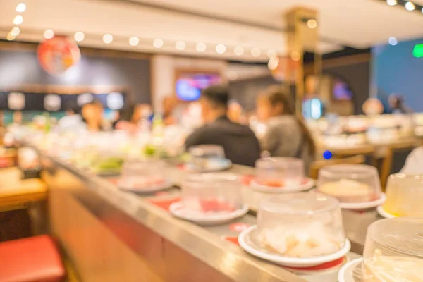 Blurred background Interior of cozy restaurant. Contemporary design in loft style, modern dining place and bar counter, copy space. Hot pot conveyor.