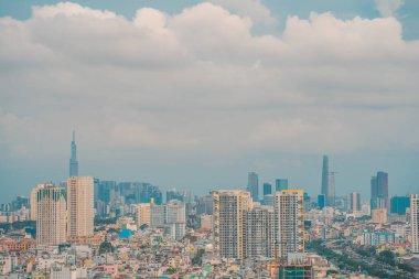 Aerial view of Bitexco Tower, buildings, roads, Vo Van Kiet road in Ho Chi Minh city - Far away is Landmark 81 skyscraper. Travel concept.